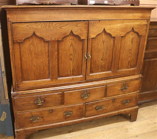 An oak dwarf linen press with five drawers under, W.140cm